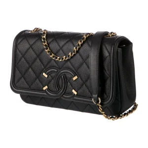 a black purse with gold chains