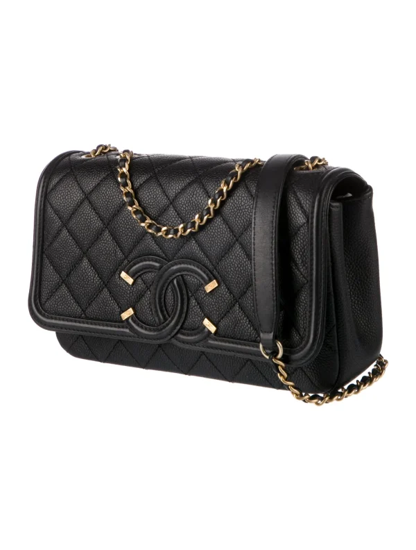 a black purse with gold chains